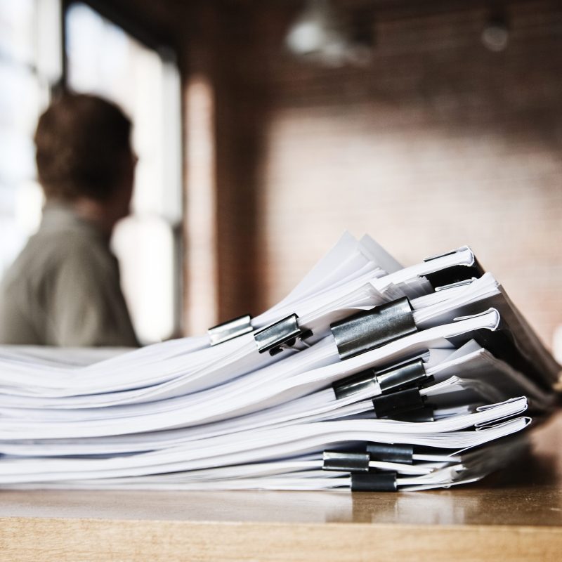 Close-up of files and file folders on a desk top in an office.
