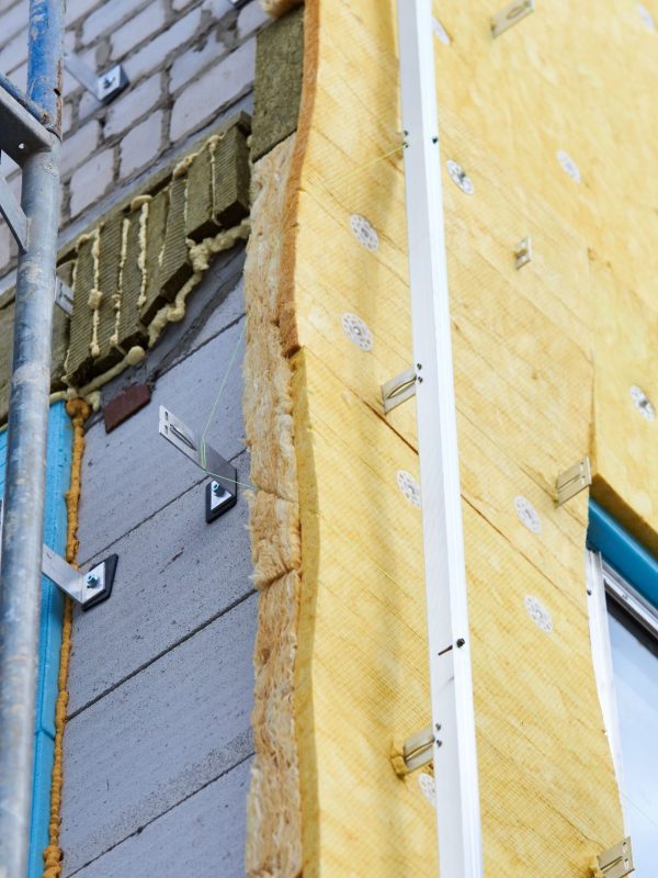 office building under construction. Facing and insulation of walls.